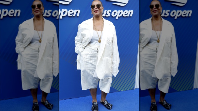 Queen Latifah wearing an oversized white outfit and ill-fitting black shoes at the US Open 2025