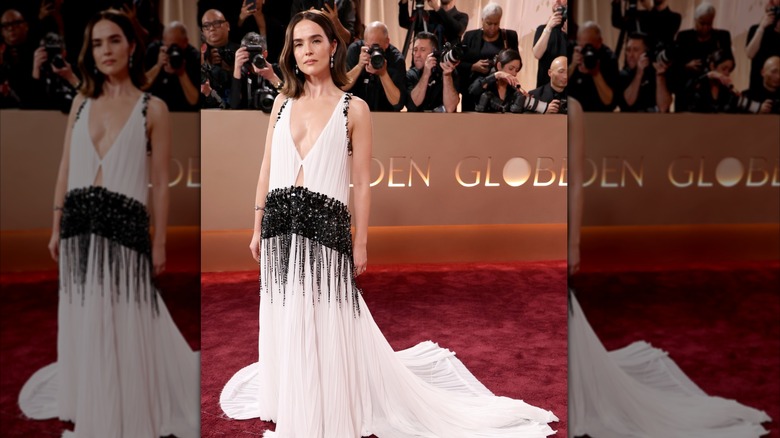 Zoey Deutch stands for photos at the Golden Globes