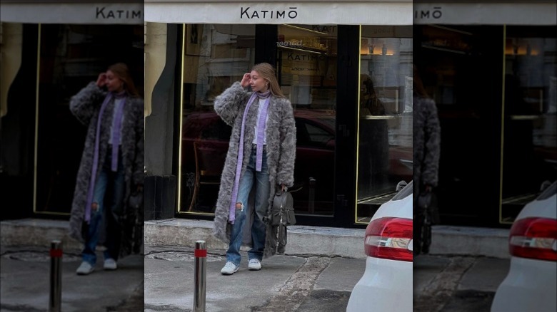 a woman wearing a purple skinny scarf