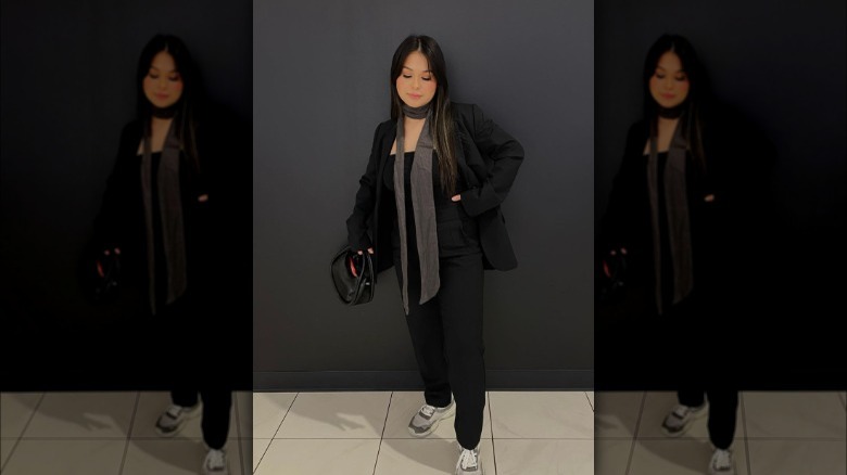 a woman wearing a gray skinny scarf