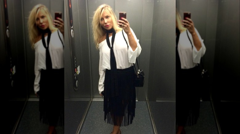 a woman wearing a black skinny scarf