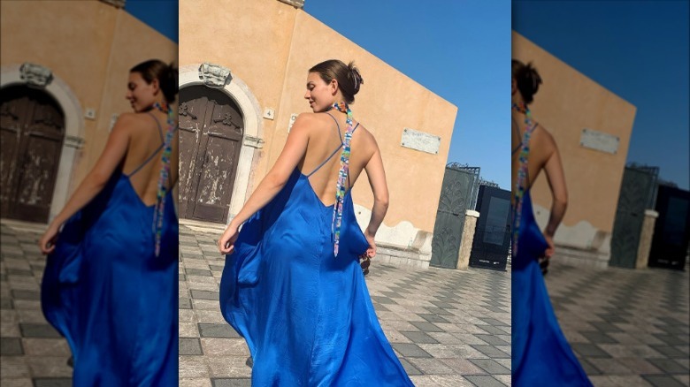 a woman wearing a colorful skinny scarf