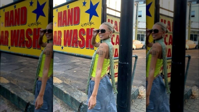 a woman wearing a mint green skinny scarf