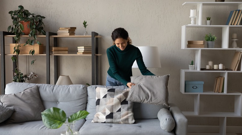 Woman cleaning her living room