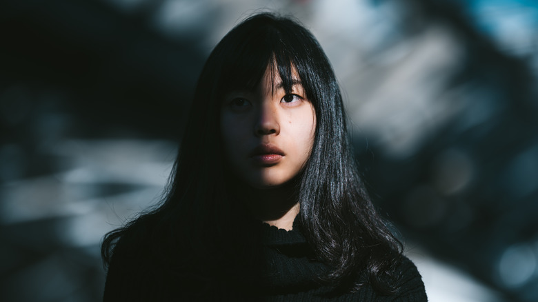 Woman with light on half of her face