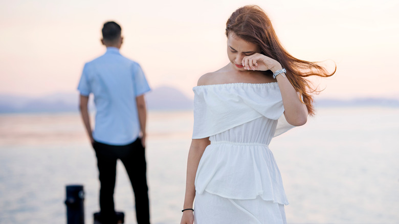 Crying woman on a beach