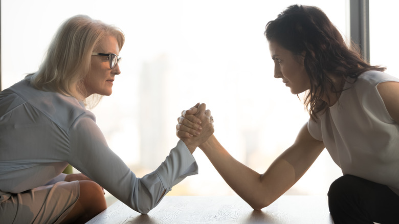 Two women arm wrestling
