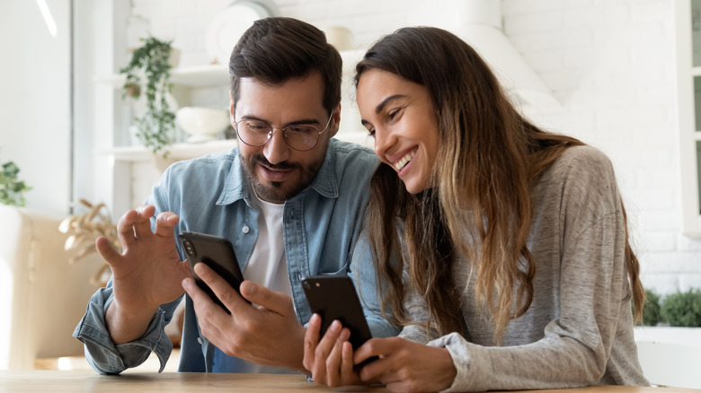 couple holding phones