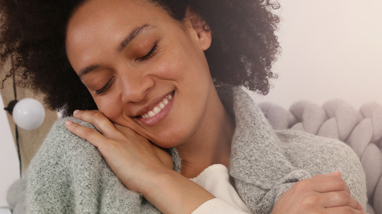 woman hugging herself 