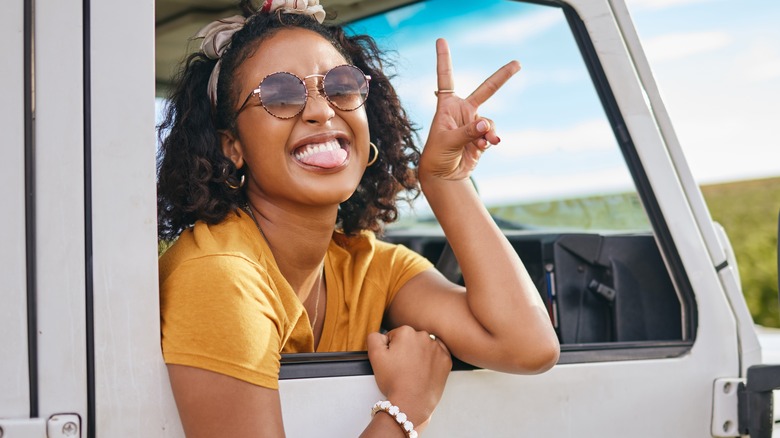 Grinning Black woman on road trip