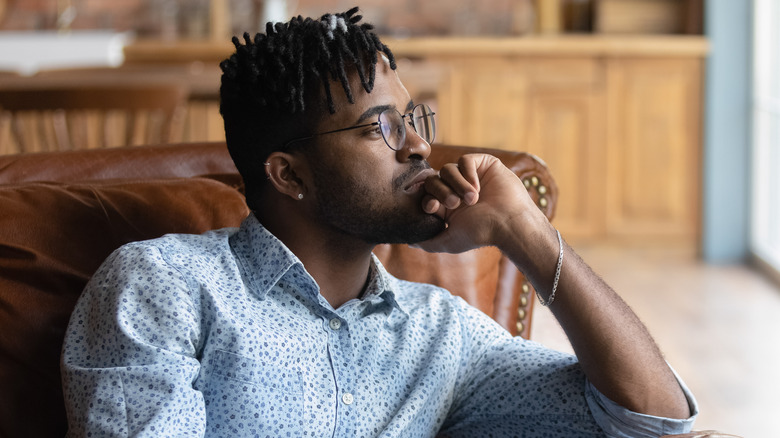 Thoughtful man looking out window