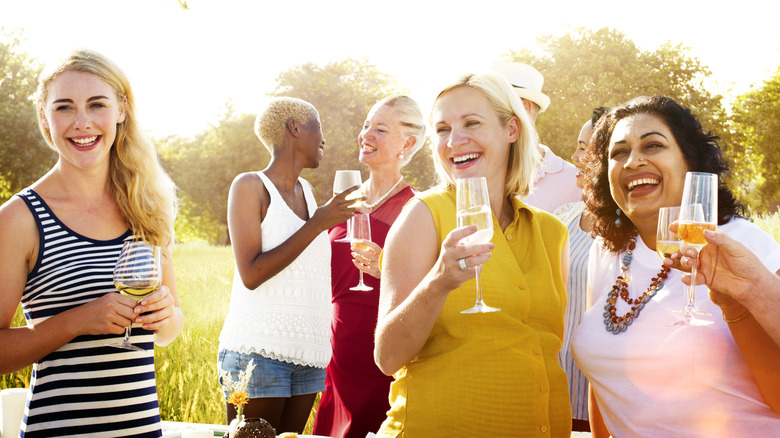 Women at backyard party laughing