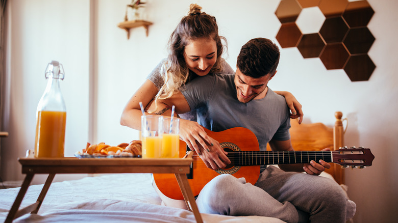 A couple having breakfast in bed