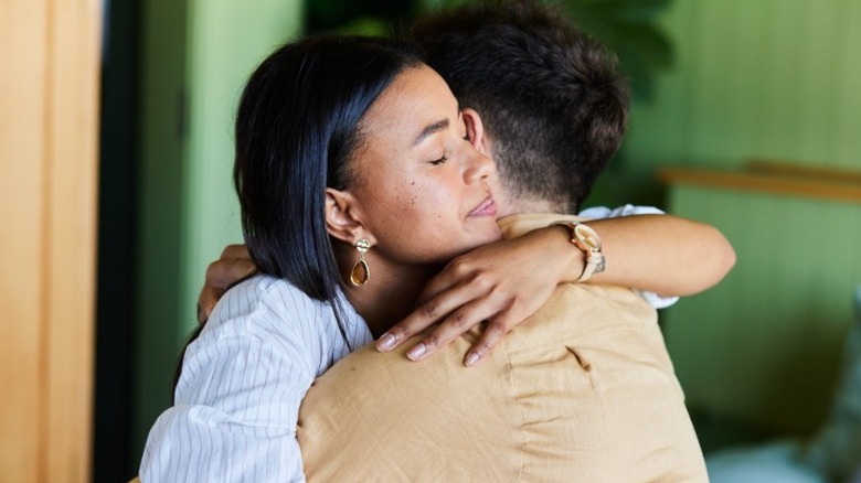 A man comforting a woman