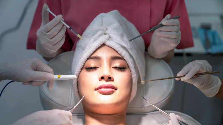 A woman preparing to have facial injections