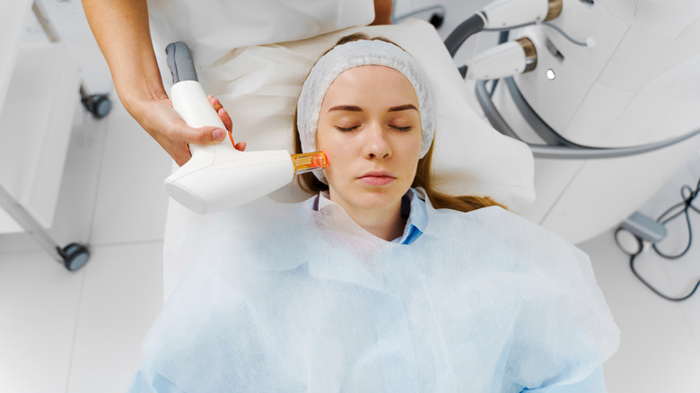 A patient receiving IPL therapy on her face