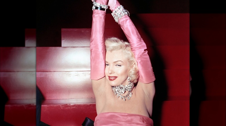 Marilyn Monroe in pink dress with elbow length gloves, drenched in jewels for "Gentlemen Prefer Blondes"