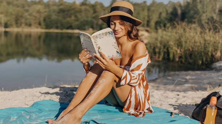 Woman sitting on a beach reading