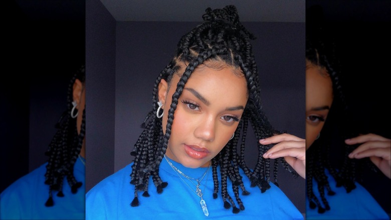 woman with braided hair in half bun