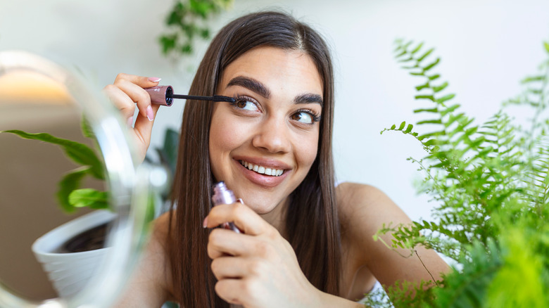 Woman applying mascara