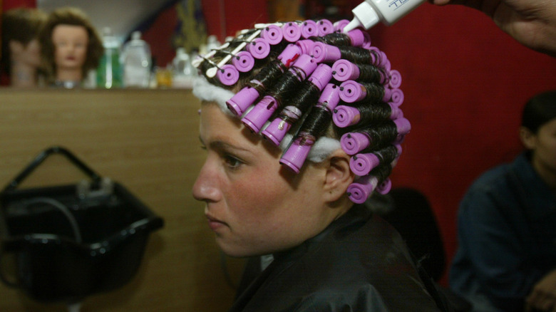 A woman getting a perm done
