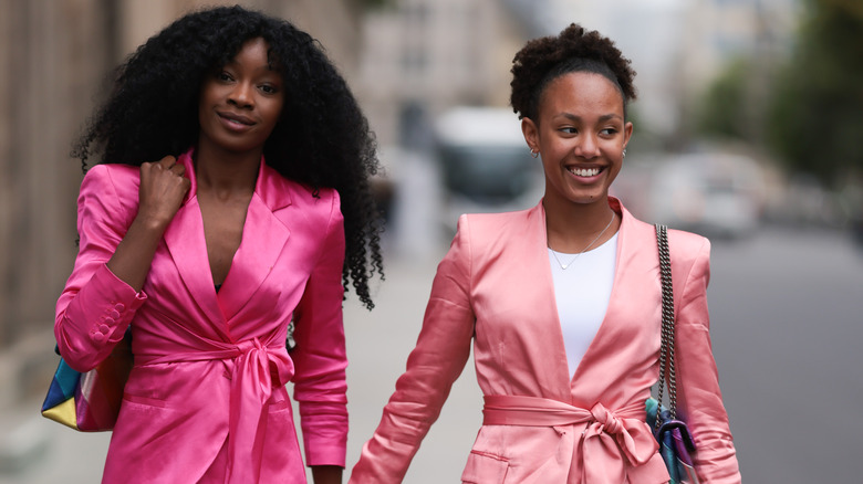 Two women wearing shoulder pads