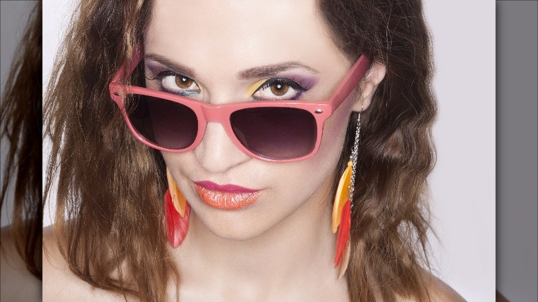 Woman with long feather earrings