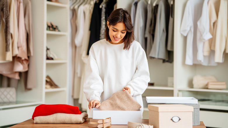 Woman storing sweaters