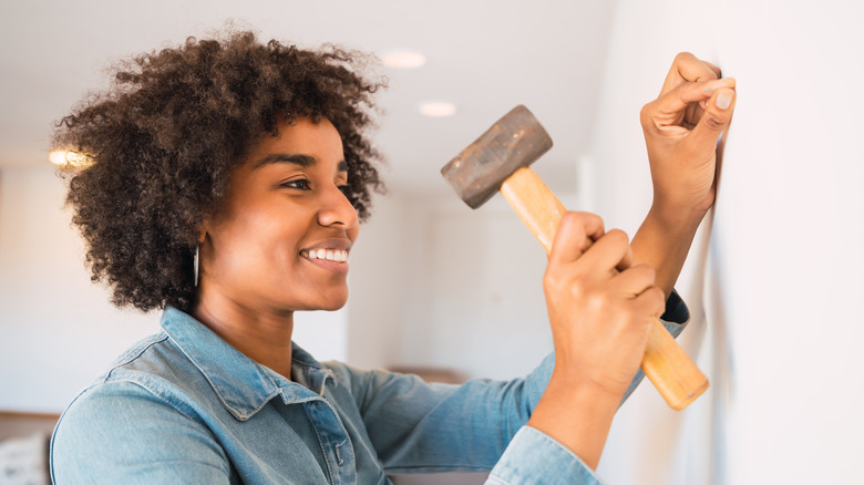 person hammering a nail