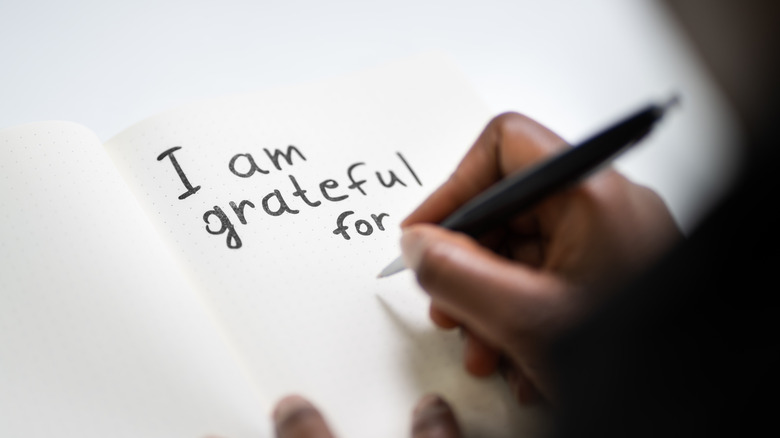 person writing a letter