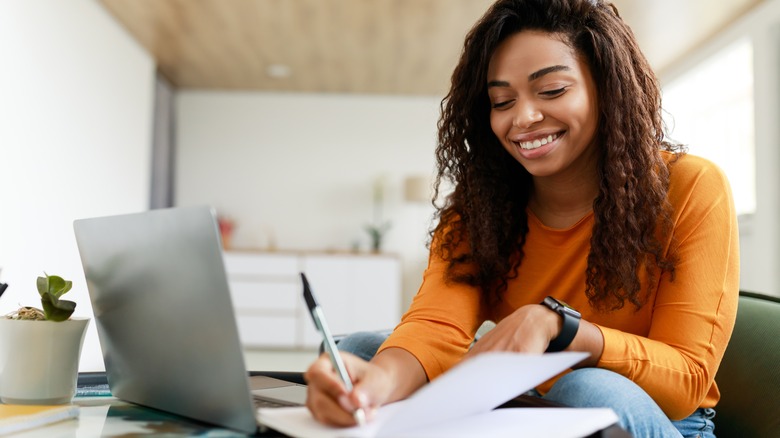 woman writing on paper