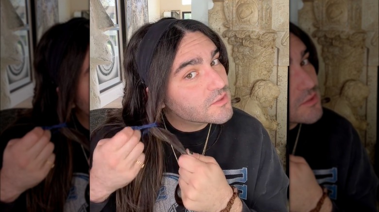 Long-haired person wearing headband