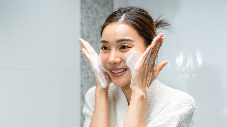 Woman with cleanser on her face