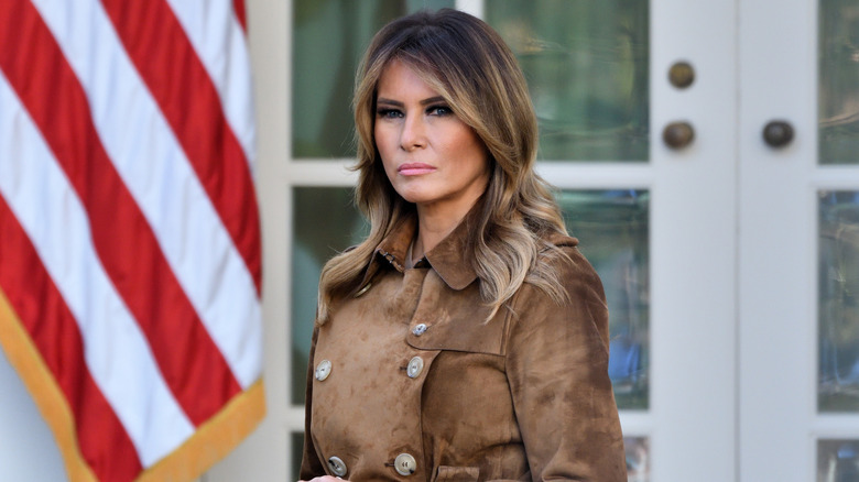Melania Trump posing in front of the American flag