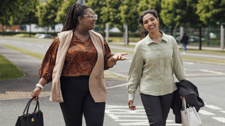 women talking while walking