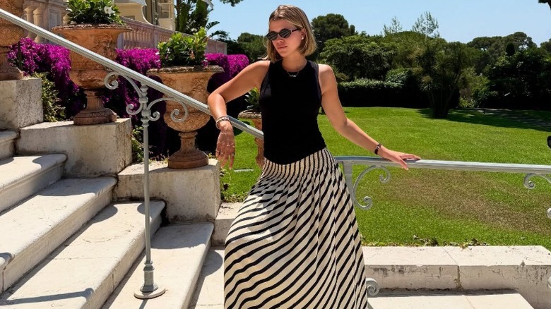 Sofia Richie Grainge poses in a black-and-white maxi skirt on vacation
