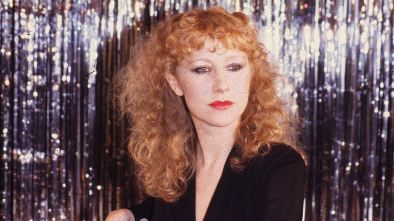 Young Helen Mirren posing on a chair in 1976