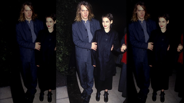 Winona Ryder and Dave Pirner wearing black and posing together at an event.