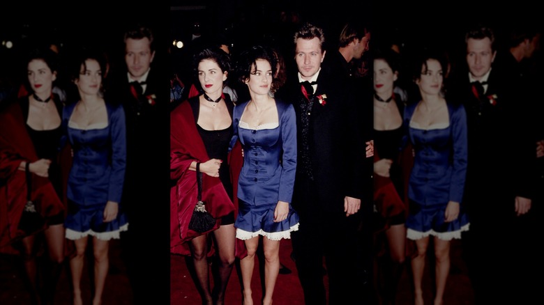 Winona Ryder in a blue dress standing with her Dracula co-stars at a red carpet event.
