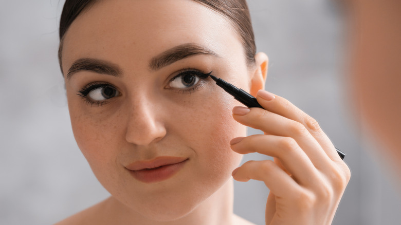 Woman applying liquid liner