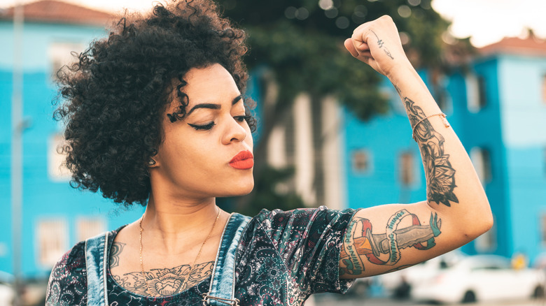 woman flexing tattooed arm