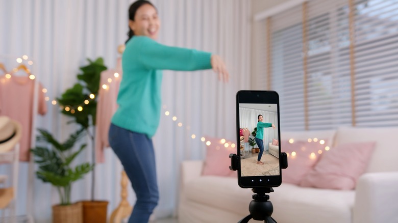 Woman filming a TikTok