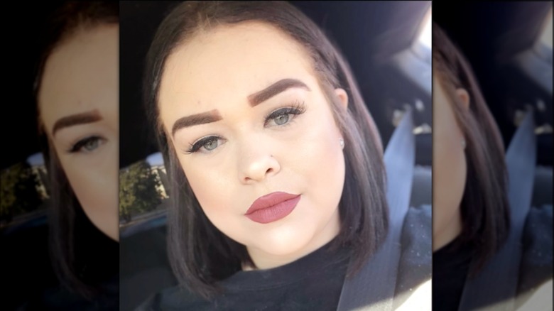 Woman with thickly drawn eyebrows