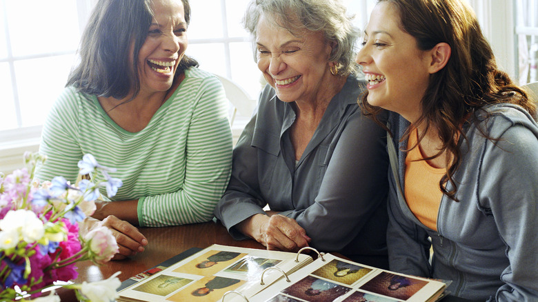 family laughing at old photos together