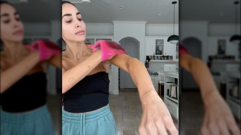 Woman applying self tanner