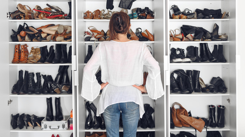 woman looking at messy closet