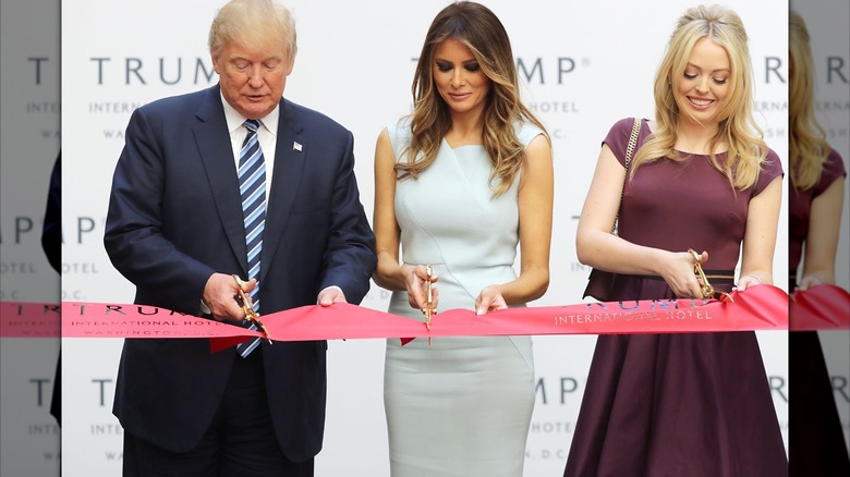 Donald, Melania, and Tiffany Trump cutting a ribbon