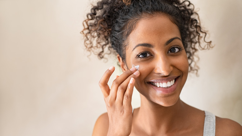 woman applying face product