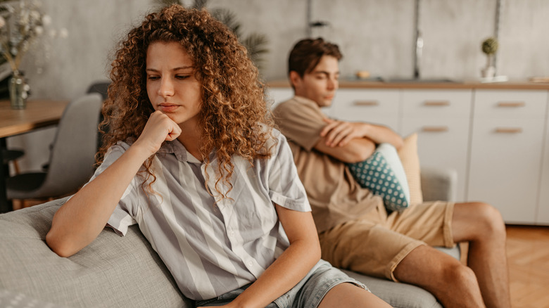 unhappy couple on sofa