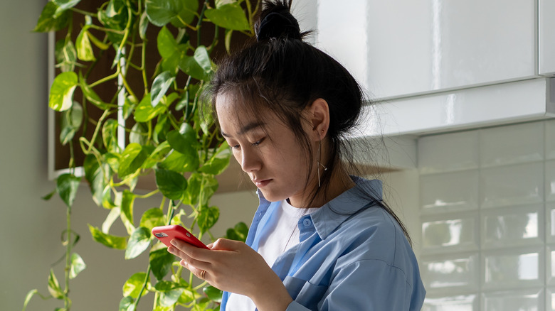 woman staring at phone